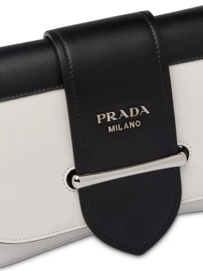 Shop Prada Buckled Sidonie Shoulder Bag In F0964 White/black