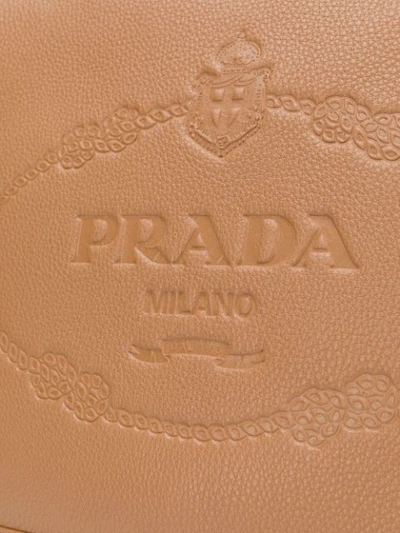 Shop Prada Embossed Logo Shoulder Bag In Brown