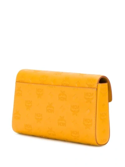 Shop Mcm Embossed Logo Crossbody Bag In Yellow