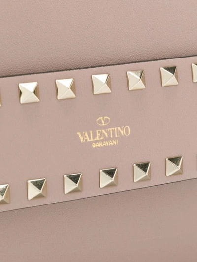 Shop Valentino Rockstud Clutch Bag In Neutrals