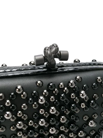 studded chain knot clutch bag