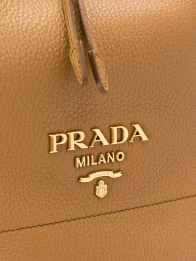 Shop Prada Logo Plaque Bucket Bag - Brown