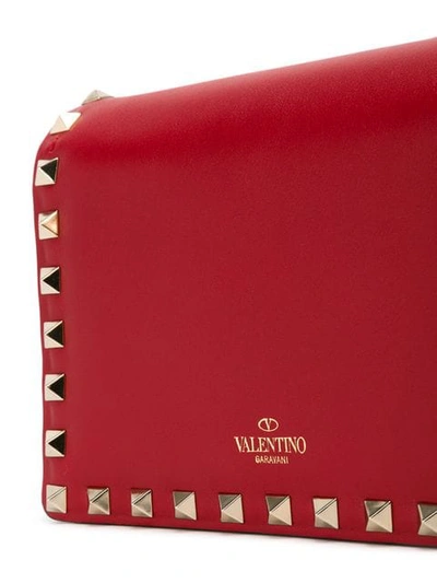 Shop Valentino Rockstud Clutch In Red