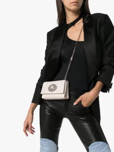 Shop Jimmy Choo Thea Crystal Buckle Clutch In Latte