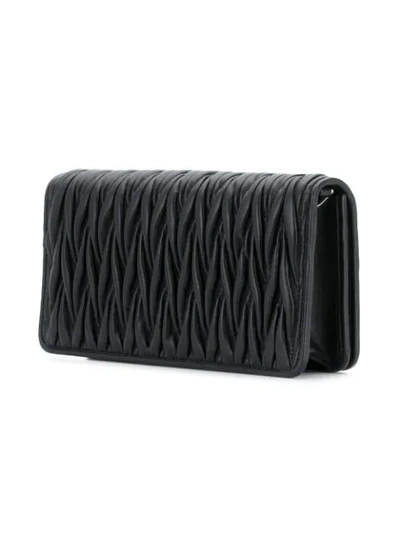 Shop Miu Miu Matelassé Clutch Bag In Black