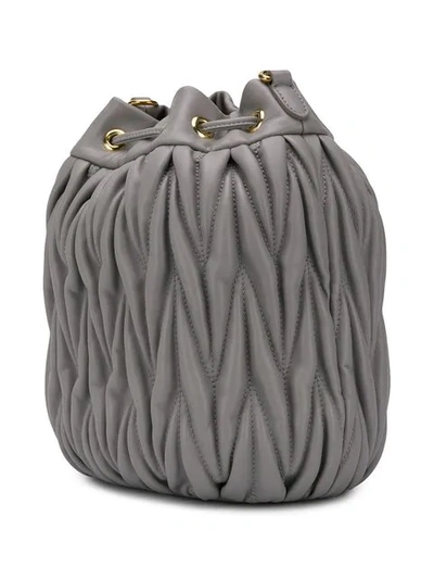 Shop Miu Miu Matelassé Bucket Bag In Grey
