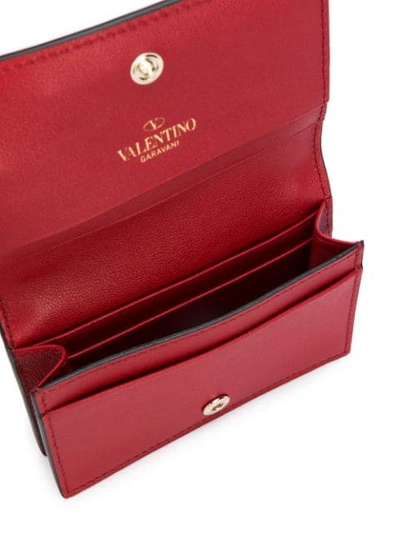 Shop Valentino Garavani Compact Rockstud Wallet In Red