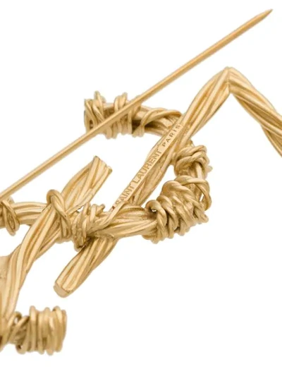 Shop Saint Laurent Ysl Twisted Brooch In Gold