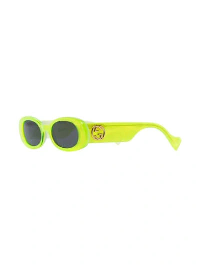 Shop Gucci Oval Frame Sunglasses In Yellow