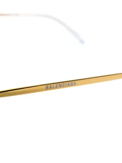 Shop Balenciaga Oval-frame Glasses In Gold