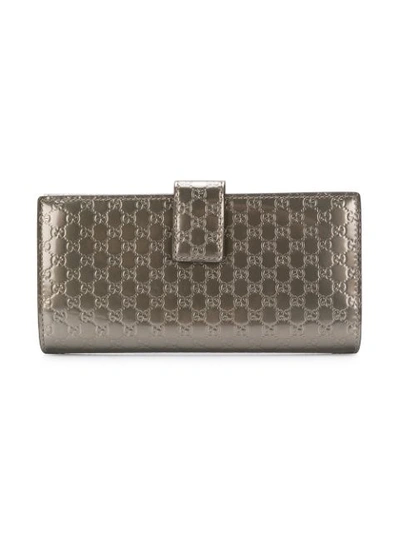 Shop Gucci Logo Embossed Wallet In Metallic