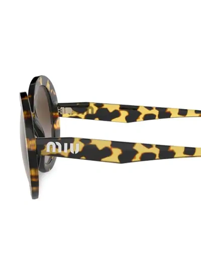 Shop Miu Miu Round Frame Sunglasses In Brown