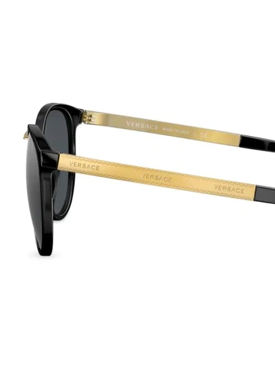 Shop Versace Round Frame Sunglasses In Black