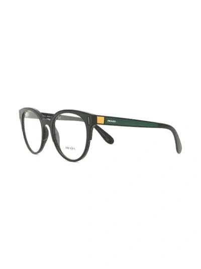 Shop Prada Rounded Cat Eye Glasses In Black