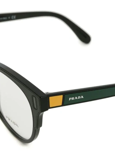 Shop Prada Rounded Cat Eye Glasses In Black
