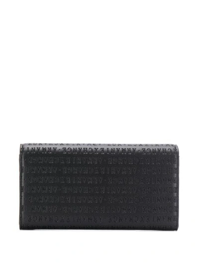 Shop Armani Exchange Logo Embossed Wallet In Black