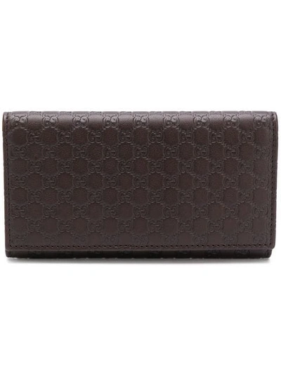 Shop Gucci Signature Foldover Wallet In Brown