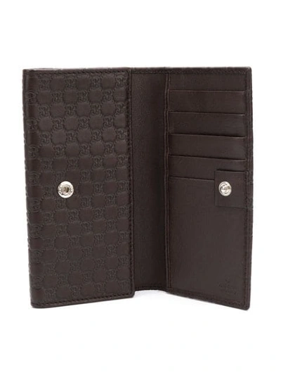 Shop Gucci Signature Foldover Wallet In Brown