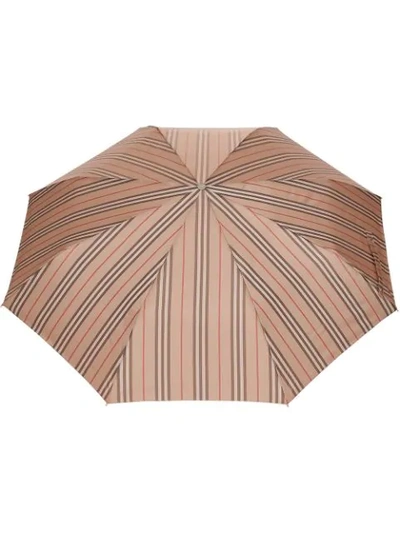 Shop Burberry Icon Stripe Folding Umbrella In Neutrals