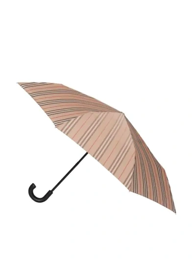 Shop Burberry Icon Stripe Folding Umbrella In Neutrals