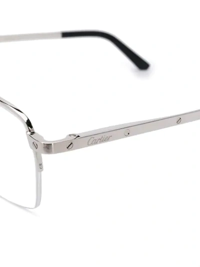 Shop Cartier Metallic Framed Glasses In Silver