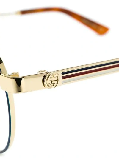 Shop Gucci Round Glasses In Metallic