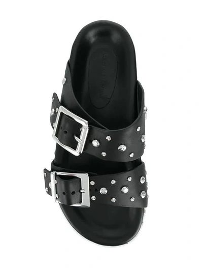 Shop Alexander Mcqueen Buckled Slides In Black