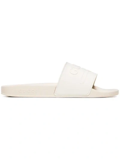 Shop Gucci Embossed Logo Slides In White