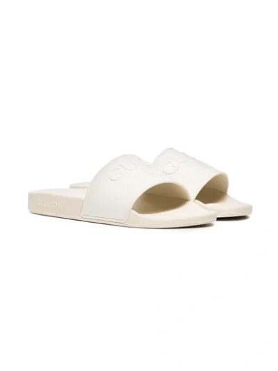 Shop Gucci Embossed Logo Slides In White