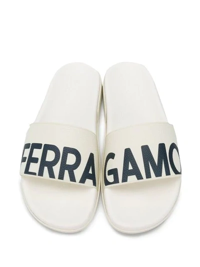 Shop Ferragamo Logo Print Slides In White