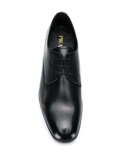 Shop Prada Logo-embossed Derby Shoes In Black