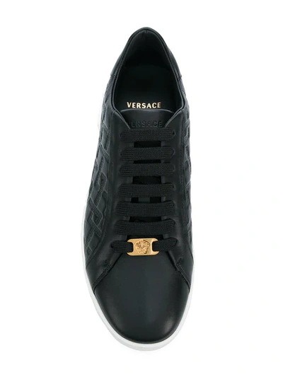 Shop Versace Grecca Embossed Sneakers In K41t Nero Oro