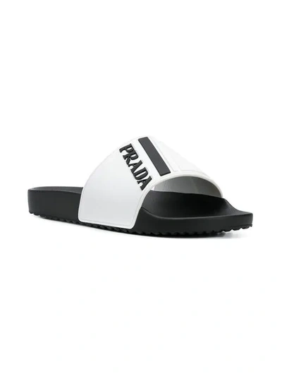 Shop Prada Logo Embossed Flat Slides In White