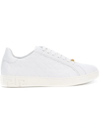 Shop Versace Grecca Embossed Sneakers In White