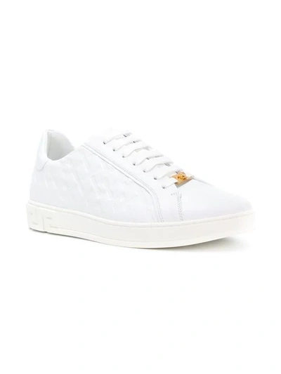 Shop Versace Grecca Embossed Sneakers In White