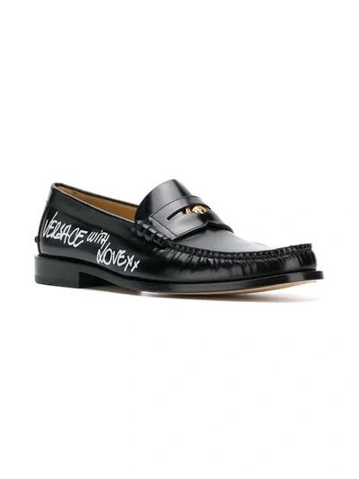 Shop Versace Lettering Logo Print Loafers In Black