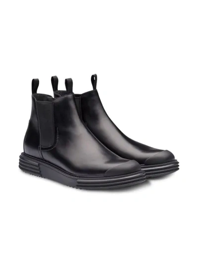 Shop Prada Lug Sole Ankle Boots In Black