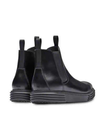 Shop Prada Lug Sole Ankle Boots In Black