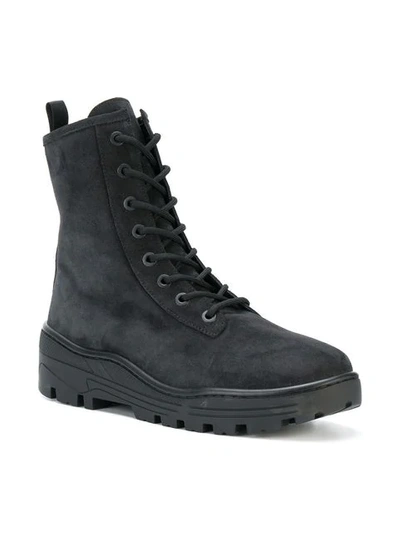 Shop Yeezy Combat Boots In Black
