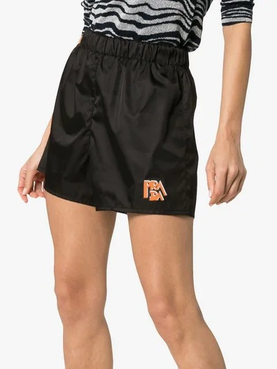 Shop Prada Logo Patch Nylon Shorts In Black