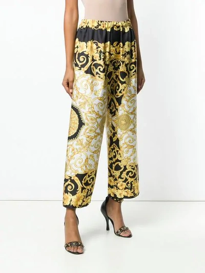 Shop Versace Baroque Print Silk Trousers In Black