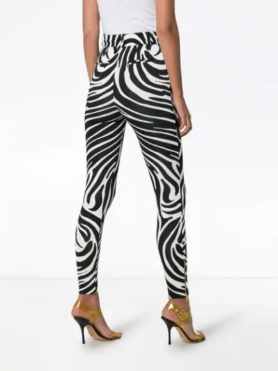 Shop Versace Zebra Print Trousers In Black