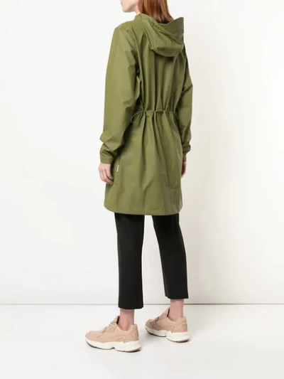 Shop Rains Hooded Raincoat In Green
