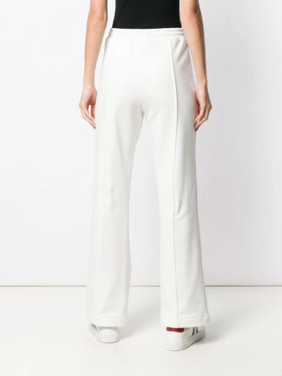 Shop Moncler Flared Track Pants In White