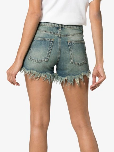 Shop Saint Laurent Low Rise Frayed Denim Shorts In Blue