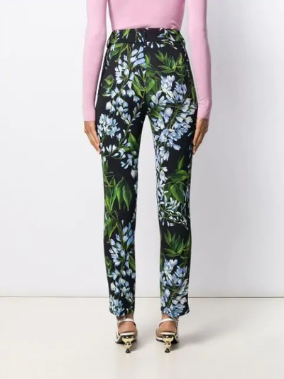 Shop Blumarine Tapered Floral Print Trousers In Black