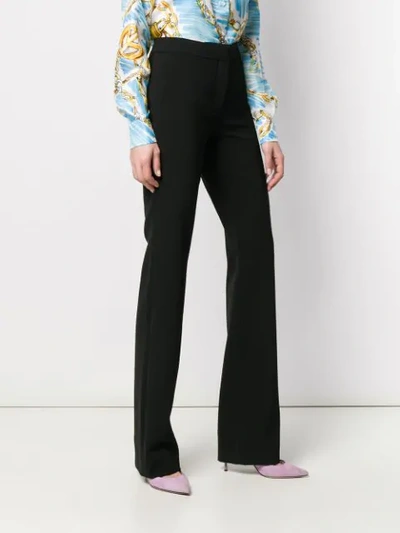 Shop Moschino Wide Leg Trousers In Black