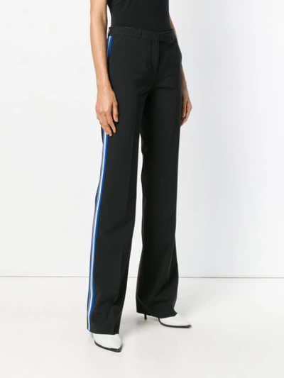 Shop Etro Side Stripe Flared Trousers In Black