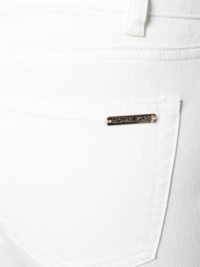 Shop Michael Michael Kors Studded Kick Flare Jeans In White