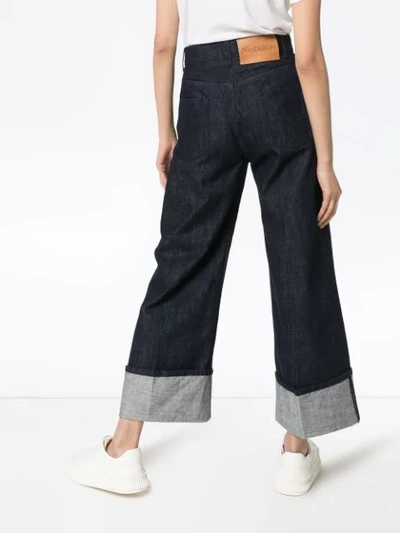 Shop Jw Anderson Turned-cuff Wide-leg Jeans In Blue